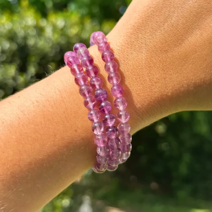 Bracelet fluorite violette au poignet d'une jeune femme