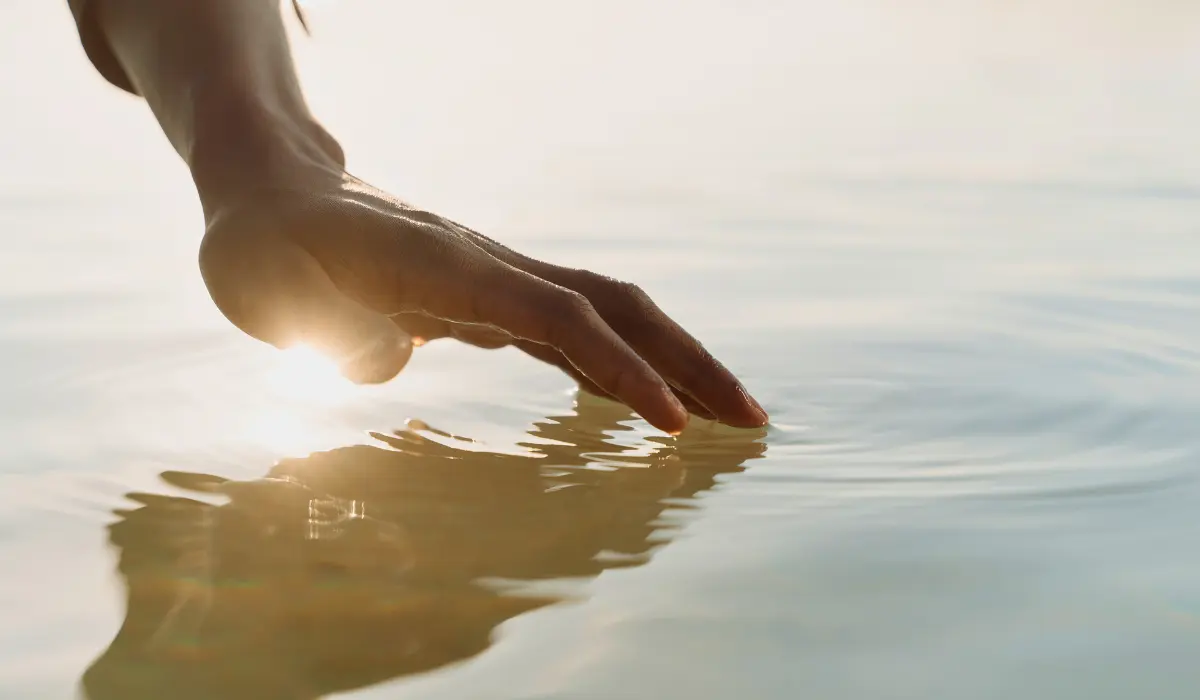 Une main à la surface de l'eau, illustrant la nécessité de réapprendre à apprécier l'ennui